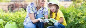 Mother and daughter planting in the garden